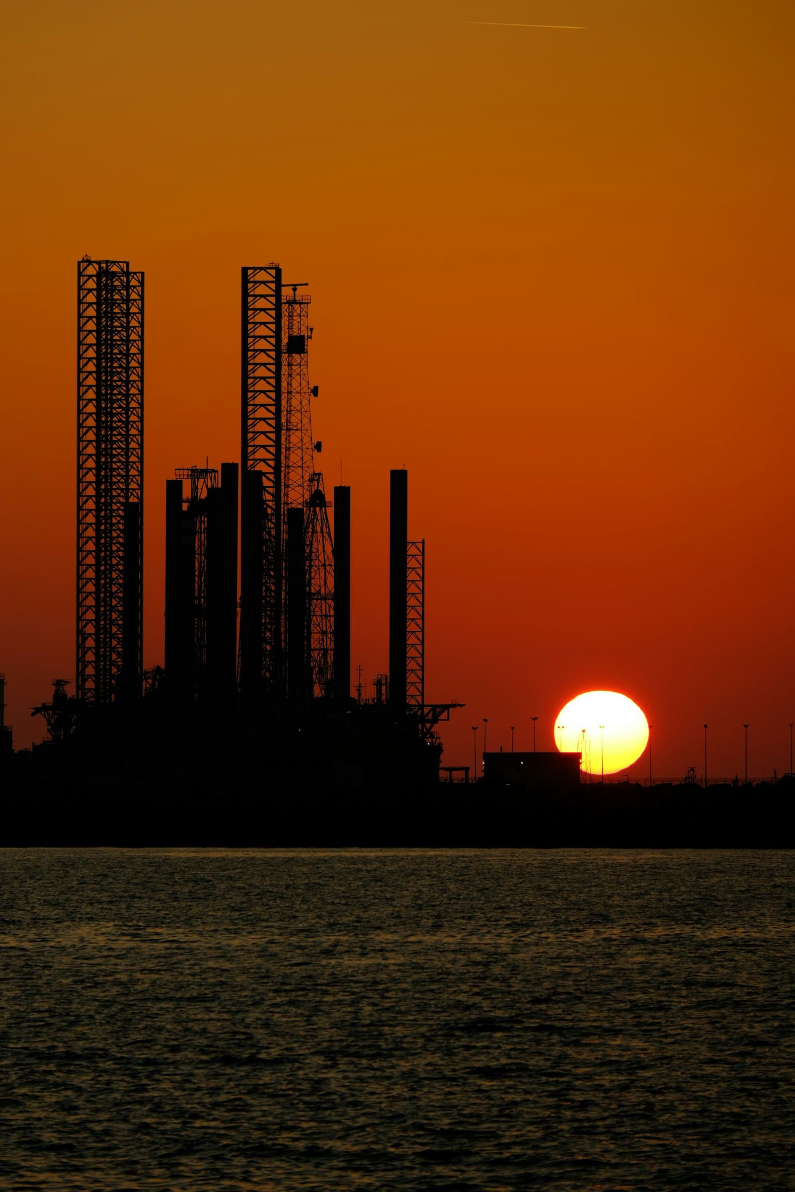 Industrial energy facility silhouetted at dusk